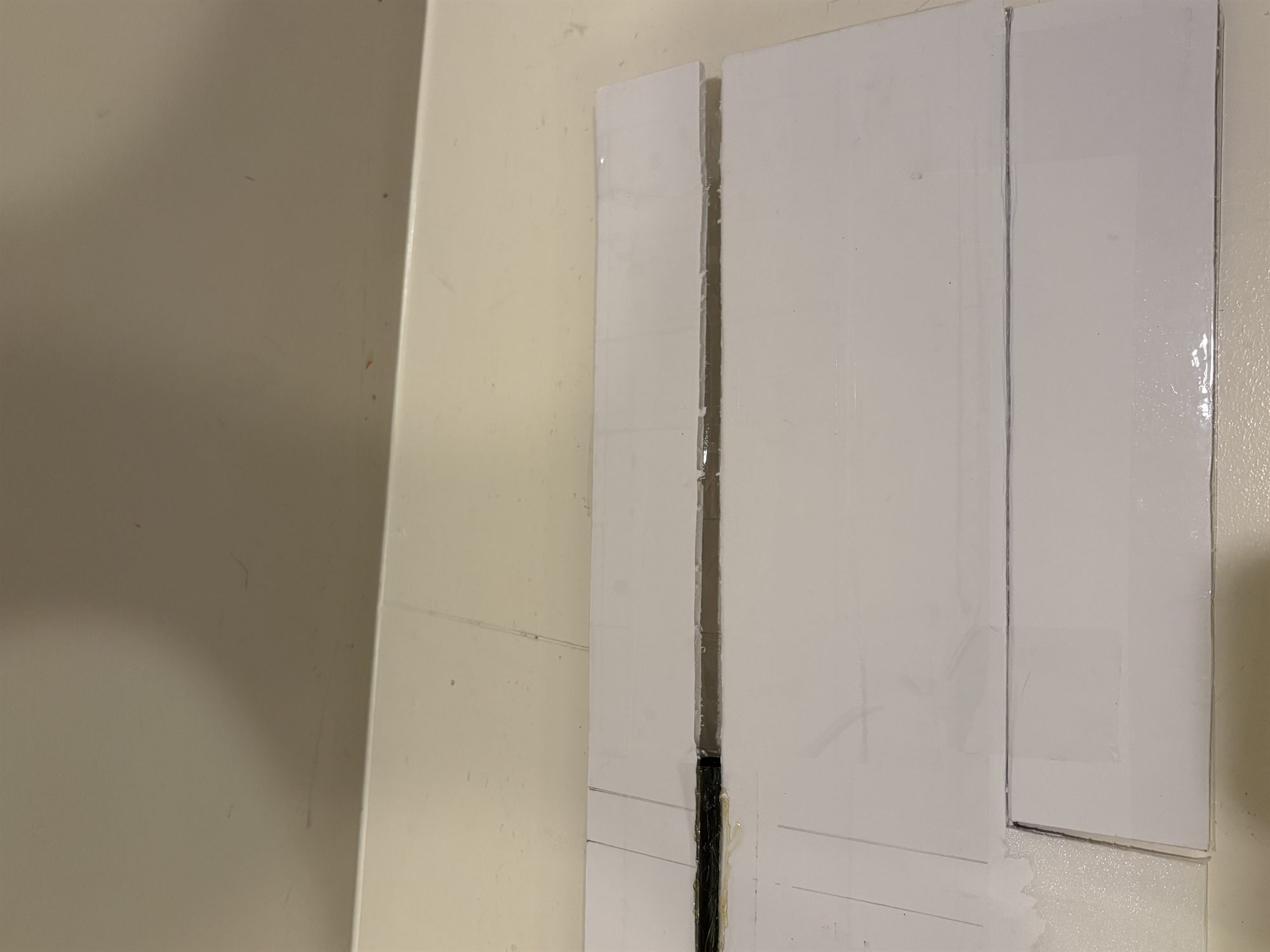 The spar tube in its channel along the foam-board wing, ending partway along and leaving the groove running on empty toward the wingtip.